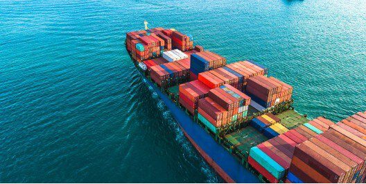 A ship in the middle of the water using IoT shipping container tracking devices