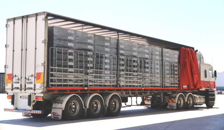 Truck loaded with smart bins that are tracked through the supply chain