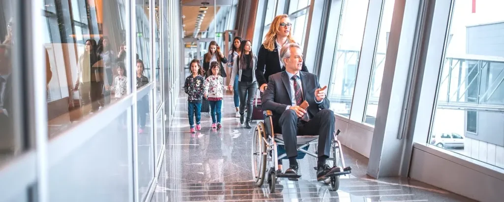 Passenger on corridor at airport terminal using a wheelchair with wheelchair tracking technology