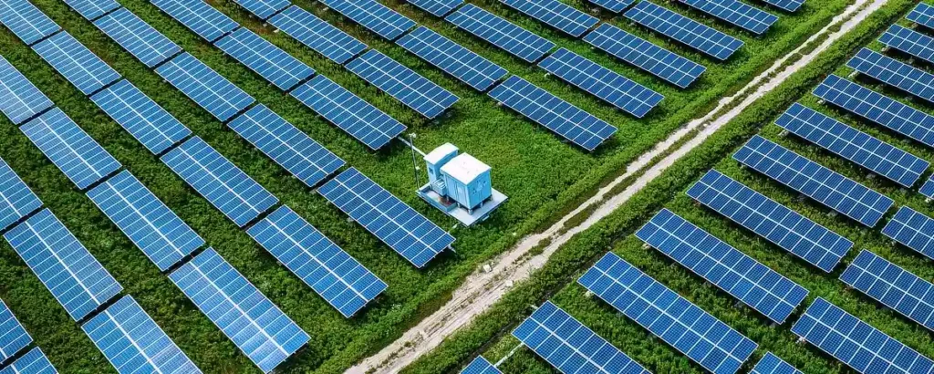 Solar panels in a field, connected to an energy storage system