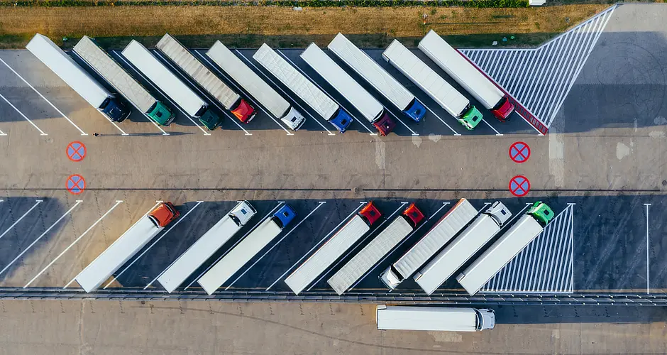 Fleet of trucks in a parking site. The trucks use LPWAN asset tracking to track their location and condition.