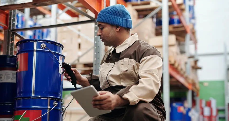 Employee scanning products with an RFID tracking system
