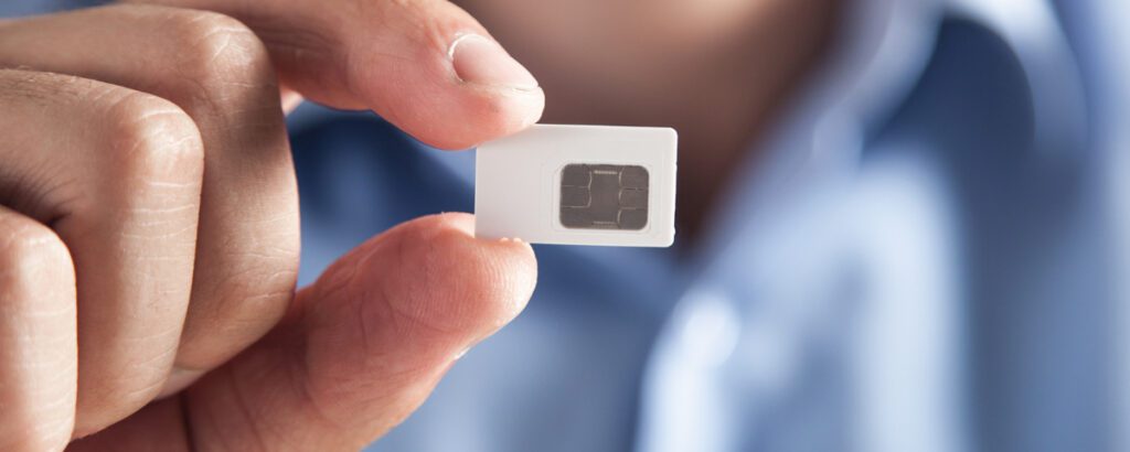 Person holding a pay-as-you-go SIMs for different devices